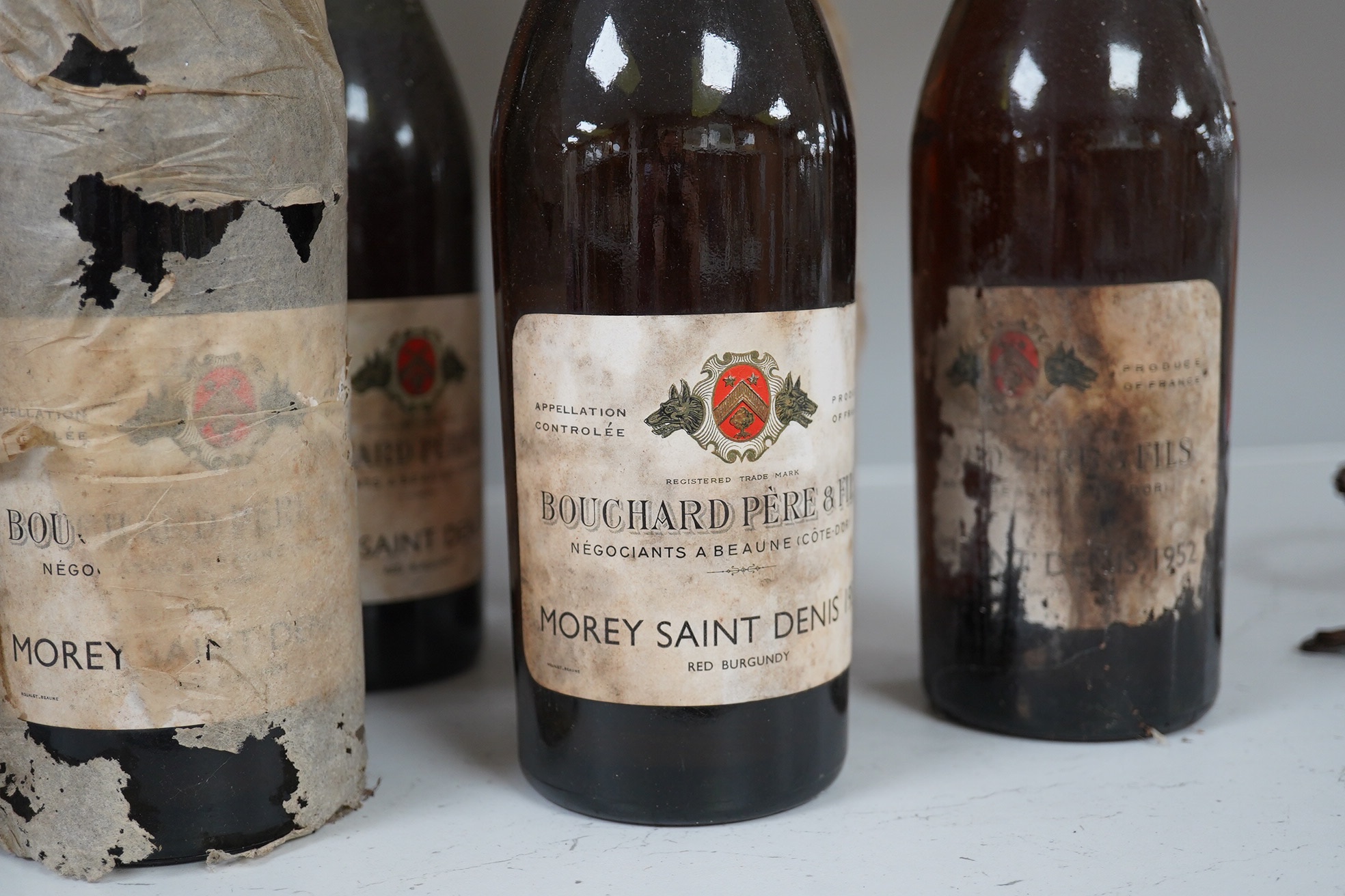 Twelve bottles of 1952 Bouchard Pere & Fils Morey Saint Denis red burgundy. Condition - fair to good, storage history unknown